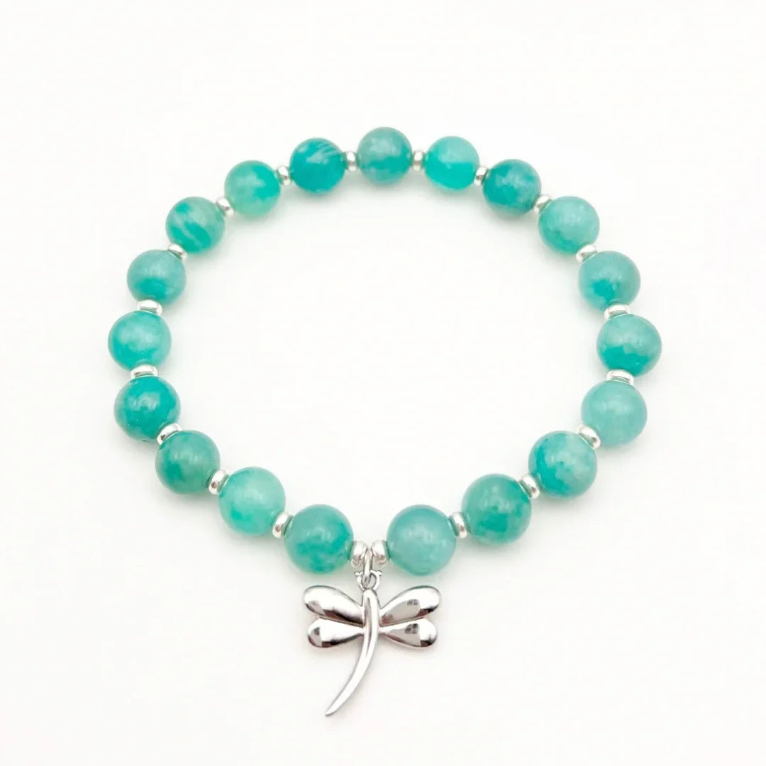 Amazonite crystal bracelet with a sterling silver dragonfly charm on a white background
