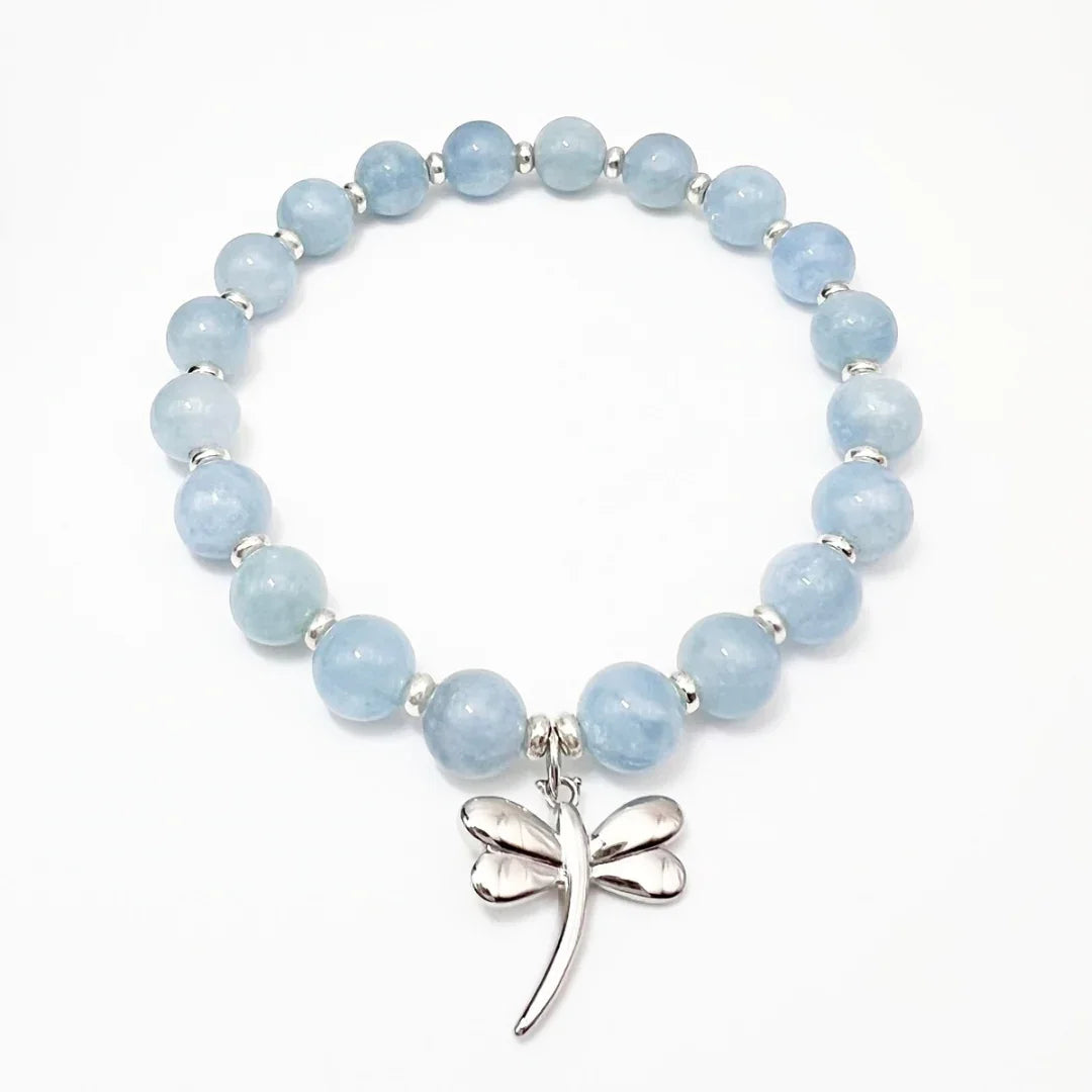 Aquamarine crystal bracelet with a sterling silver dragonfly charm on a white background